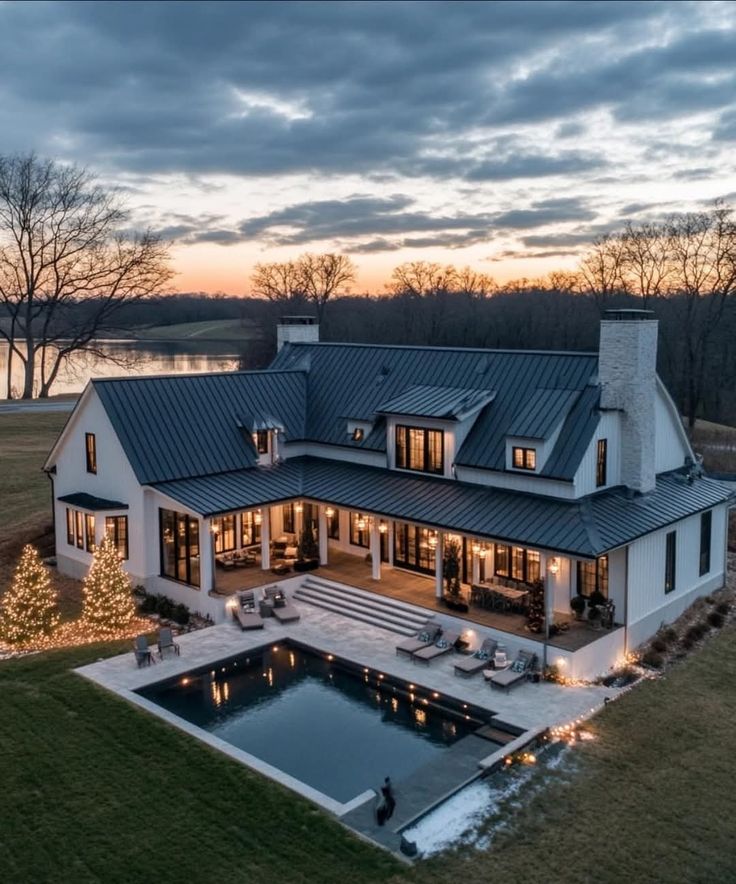 Modern farmhouse with pool at sunset